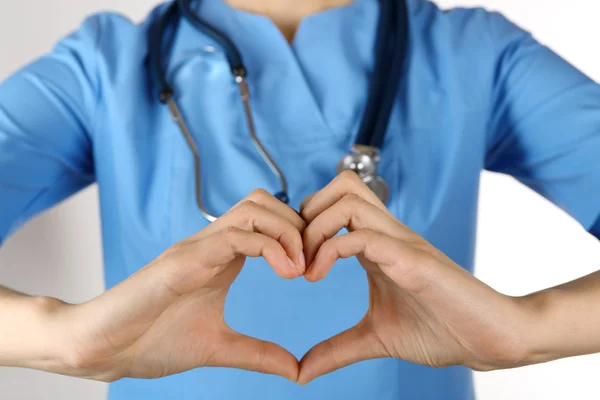 Doctor's hands making heart shape — Stock Photo, Image