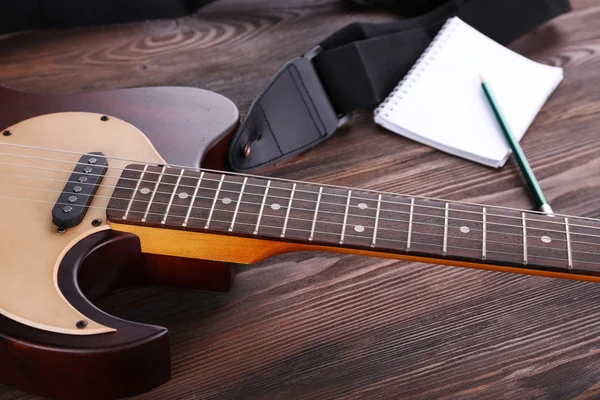 Electric guitar with notebook — Stock Photo, Image