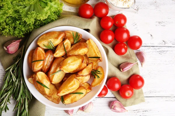 Baked potato wedges on wooden table, closeup — Stock Photo, Image