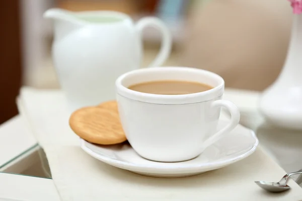 Cup of coffee on table in living room — Stock Photo, Image