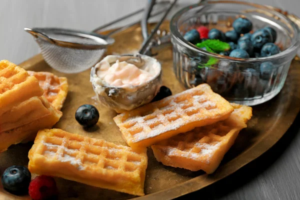 Cialde dolci fatte in casa e mirtilli su vassoio, su sfondo di legno a colori — Foto Stock