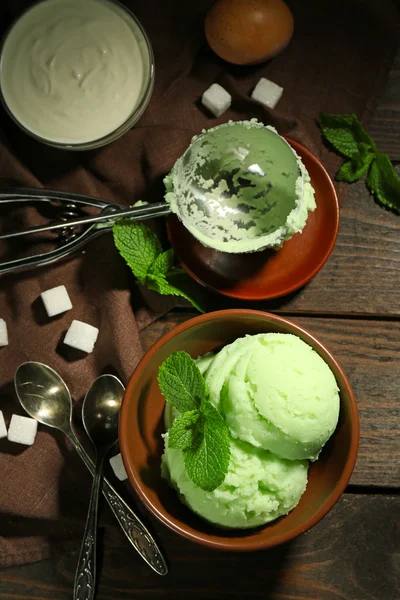 Homemade mint ice-cream on dark wooden background