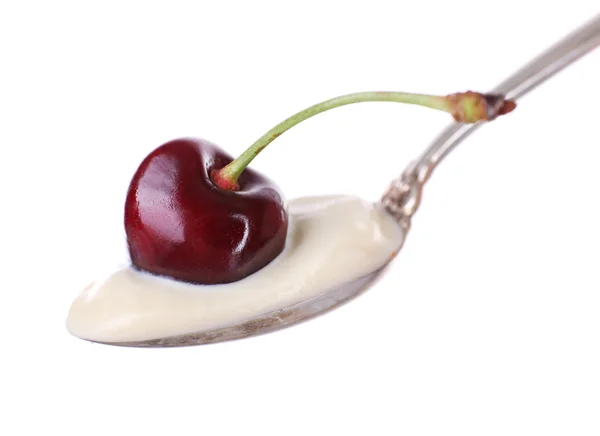 Delicious yogurt in spoon with cherry isolated on white — Stock Photo, Image