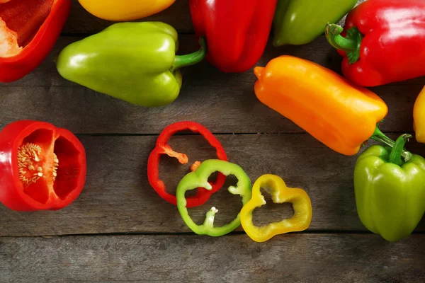 Colorful peppers on rustic wooden table, closeup — Stock Photo, Image