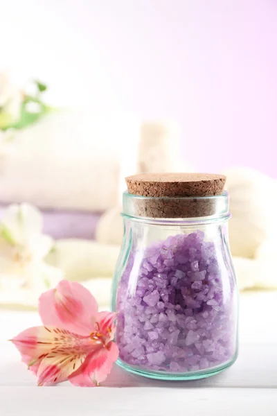 Spa treatment and flowers on wooden table, on light background — Stock Photo, Image