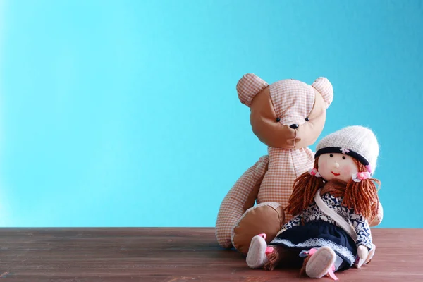 Doll and teddy bear on blue background — Stock Photo, Image