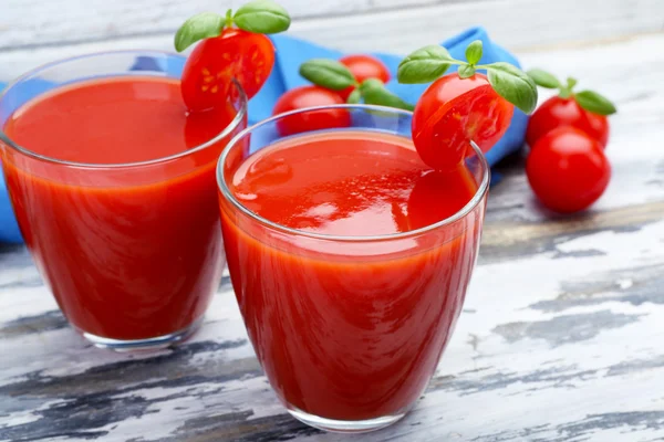 Copos de suco de tomate com legumes em fundo de madeira — Fotografia de Stock