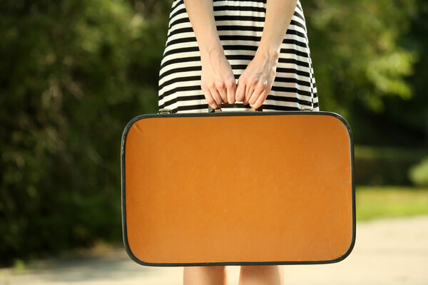 Young woman with vintage suitcase