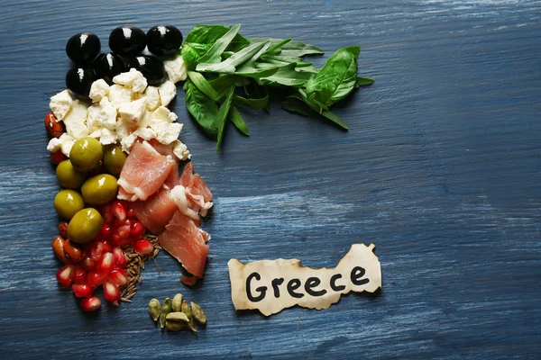 Map of Greece made with ingredients of traditional Greek cuisine on color wooden background — Stock Photo, Image