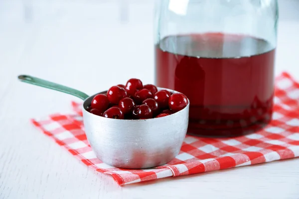 Sweet homemade cherry juice on table, on light background — Stock Photo, Image