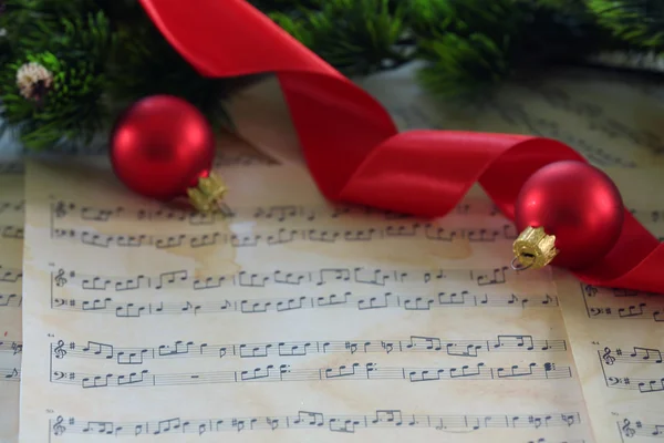 Christmas decorations on music sheets — Stock Photo, Image