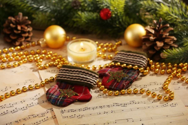 Christmas decorations on music sheets — Stock Photo, Image