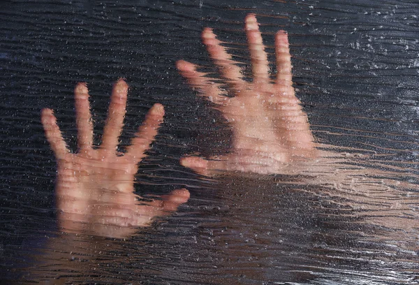 Male hands behind frosted glass — Stock Photo, Image