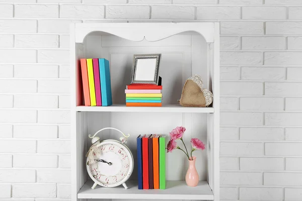 Libros y decoración en estantes en armario — Foto de Stock