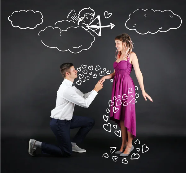 Young couple with heart and Cupid — Stock Image Young couple with heart and Cupid Royalty Free Stock Images