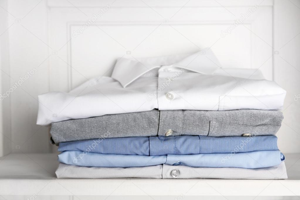 Business shirts on shelf in cupboard