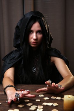 Witch - fortune teller on dark background clipart