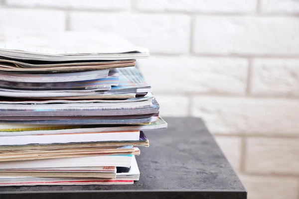 Stack of magazines on table, close up