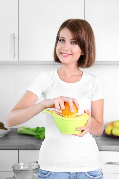 Ung vacker kvinna med citrus-frukt squeezer, förbereda apelsinjuice — Stockfoto