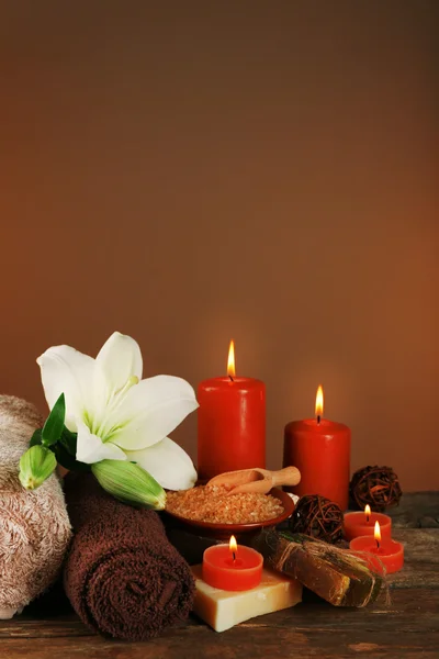 Beautiful spa composition with lily on brown background — Stock Photo, Image