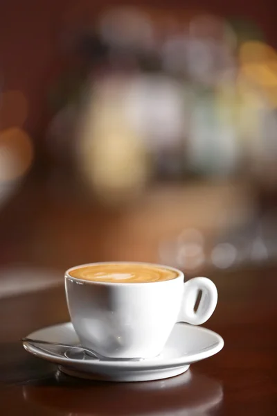 Cup of cappuccino on bar counter — Stock Photo, Image
