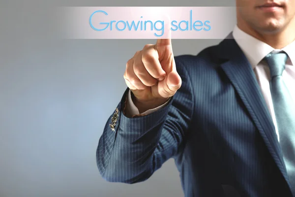 Businessman touching Growing sales icon — Stock Photo, Image