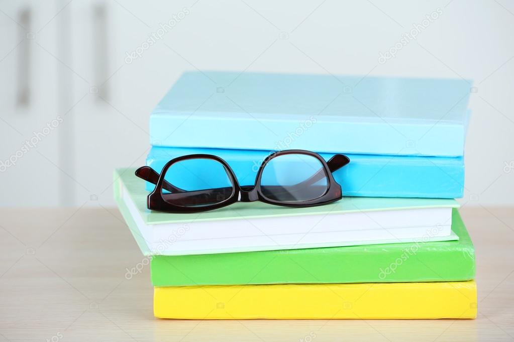 Stack of books with glasses