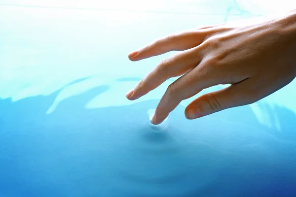 Finger touches water — Stock Photo, Image