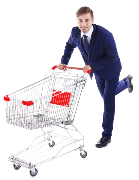 Young man with empty shopping cart — Stock Photo, Image