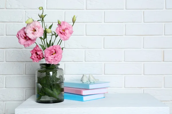 Beautiful flowers with books — Stock Photo, Image