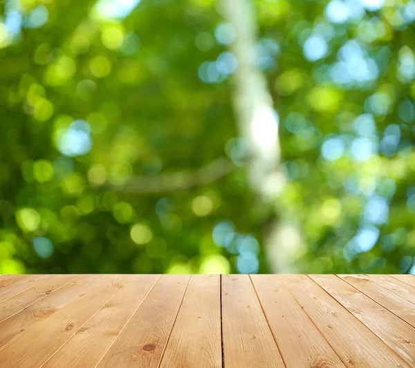 Wooden table  with abstract   background — Stock Photo, Image