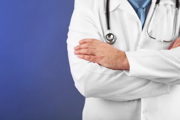Doktor s stetoskop na barevné pozadí — Stock fotografie