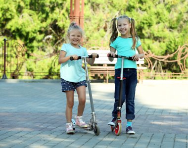 Küçük kızlar scooter üzerinde sürme