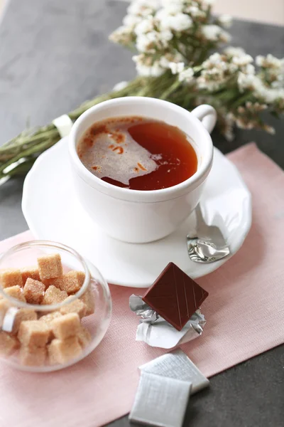 Cup of flavored coffee with chocolate on table with napkin, closeup — Stock Photo, Image