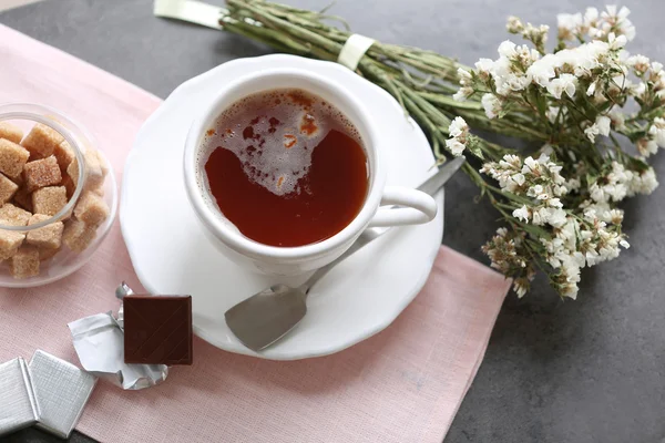 Cup of flavored coffee with chocolate on table with napkin, closeup — Stock Photo, Image