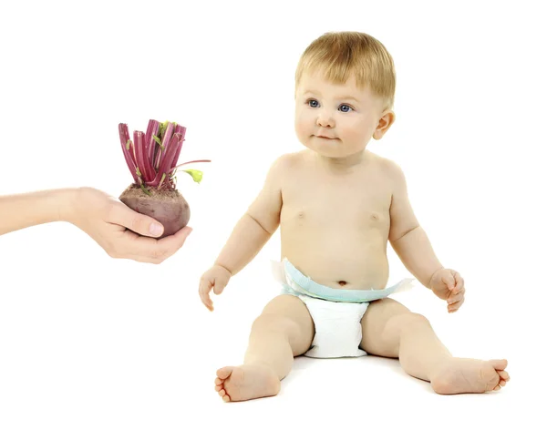 Baby boy and hand holding beetroot — Stock Photo, Image