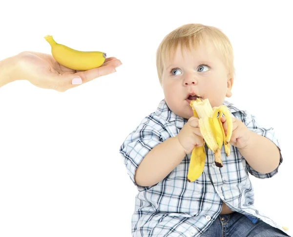 Feeding baby boy with banana — Stock Photo, Image