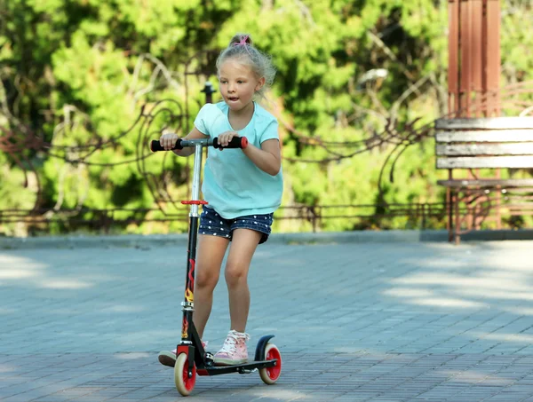 Girl riding scooter — Stock Photo, Image