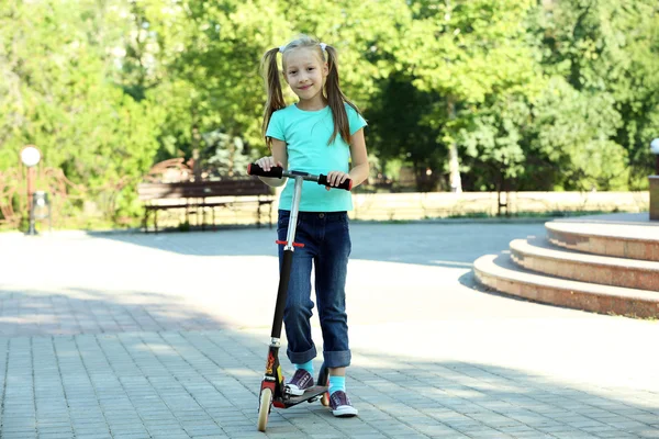 Girl riding on scooter — Stock Photo, Image