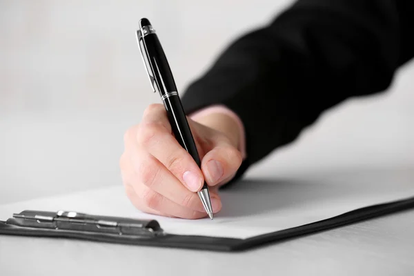Female hand with pen writing — Stock Photo, Image