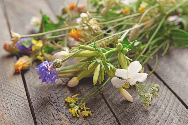 Wildflowers on wooden table — Stock Photo, Image