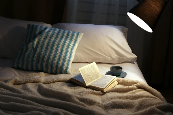 Open book on bed — Stock Photo, Image