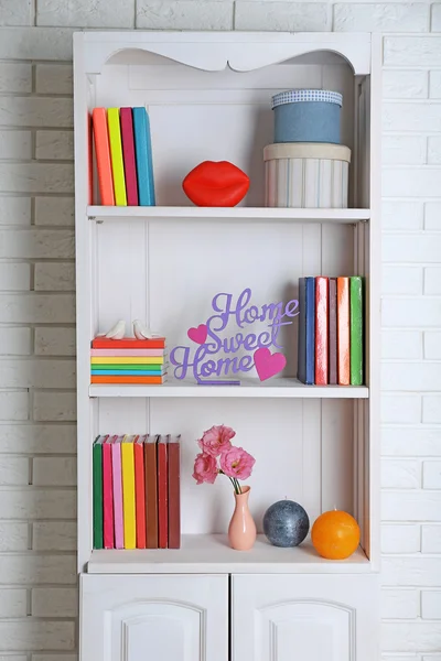 Libros y decoración en estantes en armario —  Fotos de Stock