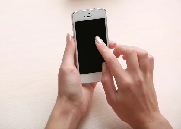 Woman using mobile phone on workplace close up — Stock Photo, Image