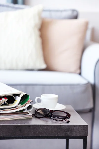 Magazines on table in living room, close up