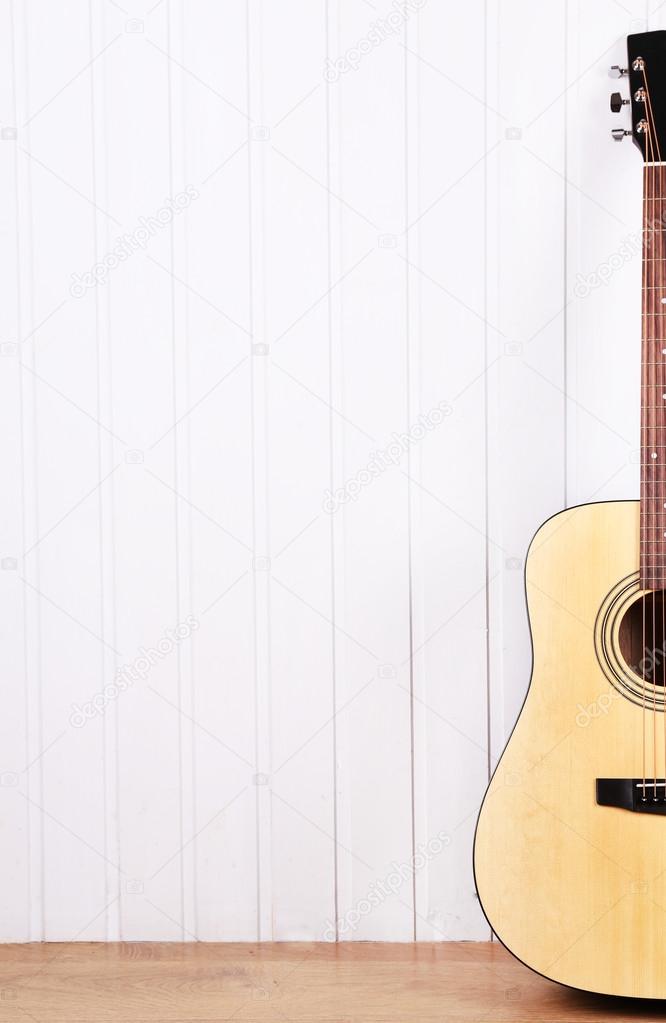 Classical guitar on white wooden wall background