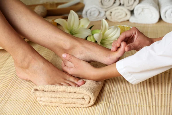 Massagista fazendo massagem nos pés no salão de spa — Fotografia de Stock