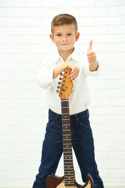 Niño con guitarra sobre fondo claro — Foto de Stock