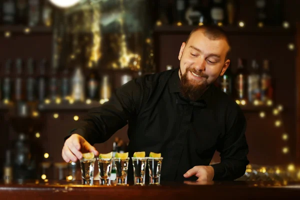 Bartender with tequila glasses — Stock Photo, Image