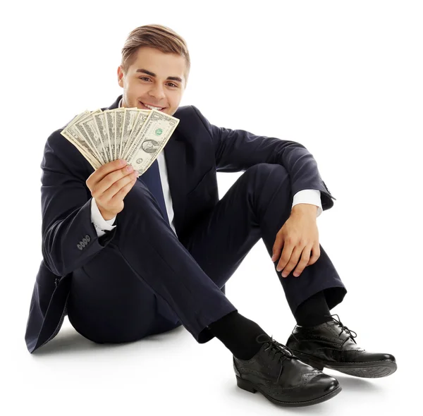 Елегантний чоловік у костюмі тримає гроші ізольовано на білому — стокове фото